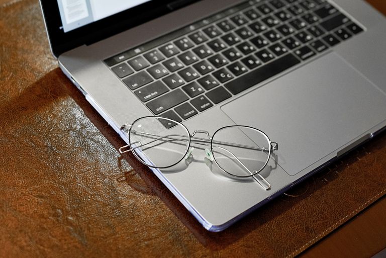 A pair of modern prescription glasses resting on a surface, illustrating how to find the best budget prescription glasses on Amazon UK.