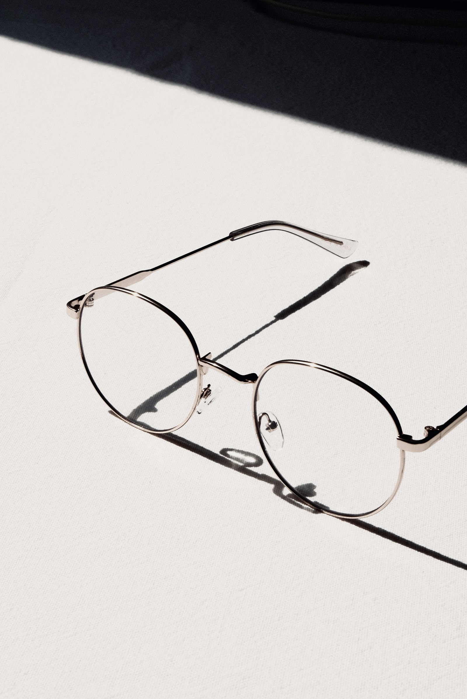 Varifocal glasses guide - minimal glasses with shadow on white.